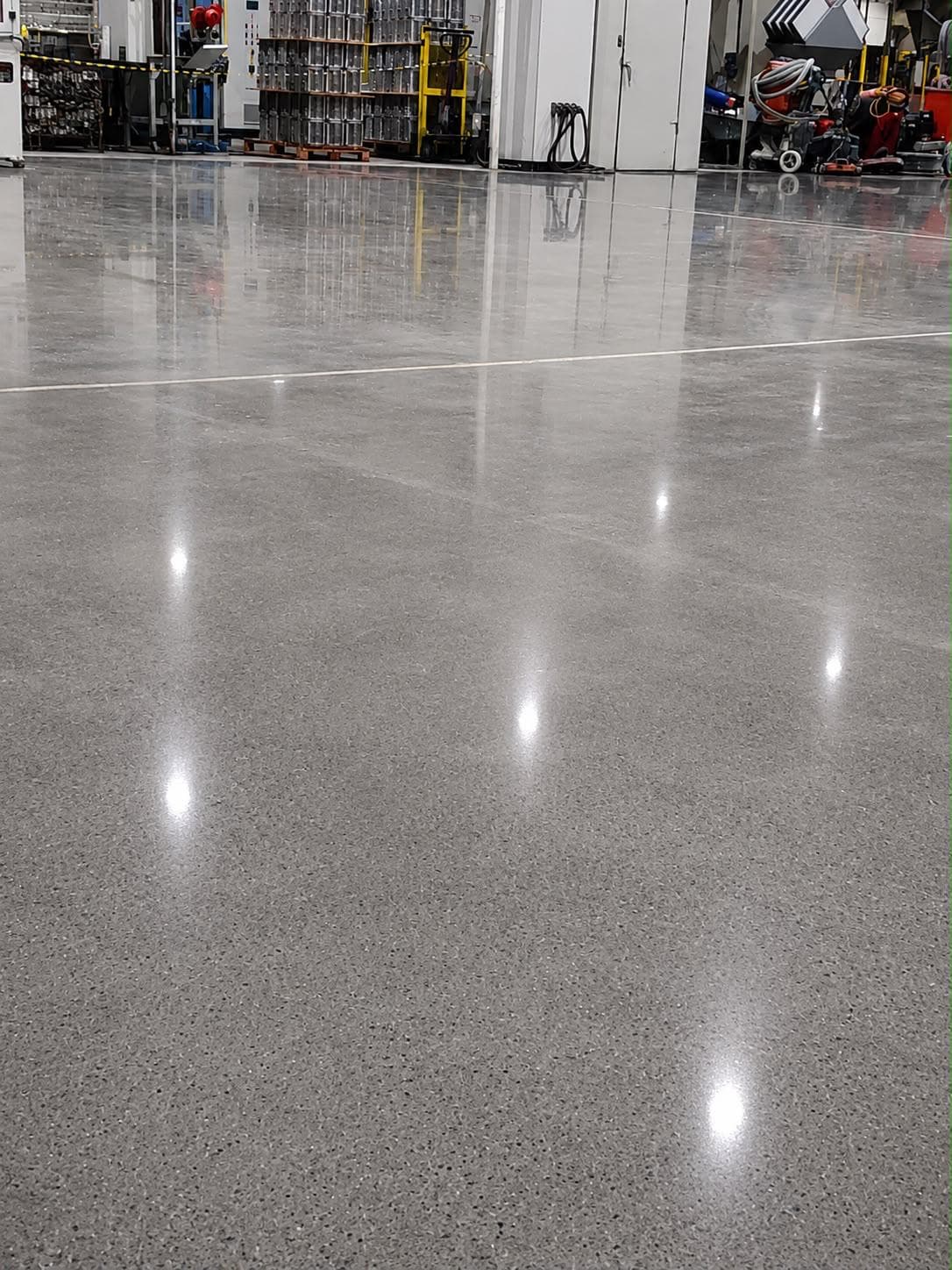Superfície espelhada de piso de concreto polido em área industrial